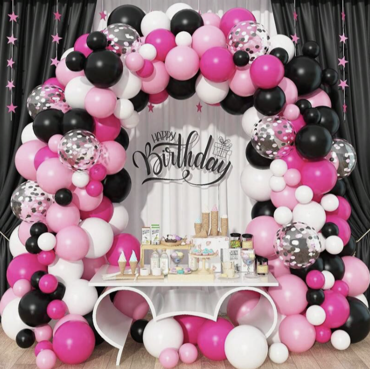 black pink and white birthday theme balloon arch and cake table